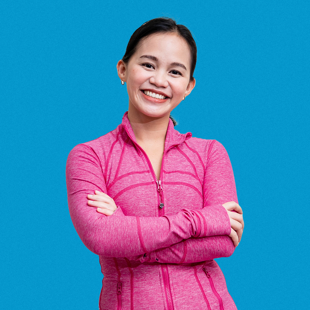 Studio director at Halcyon FItness with arms crossed, exuding professionalism and energy