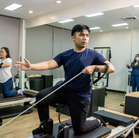 Client during a PTEX session, which includes physical therapy and Pilates